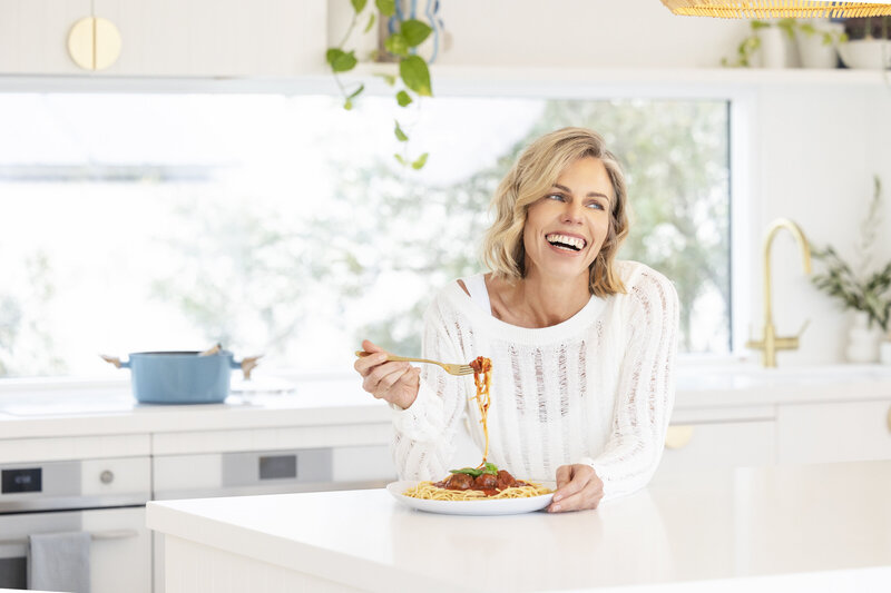 Katie Appleby enjoying a healthy snack, emphasizing how balanced nutrition supports an active and healthy lifestyle.