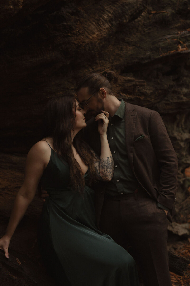 bride and groom kissing in forest