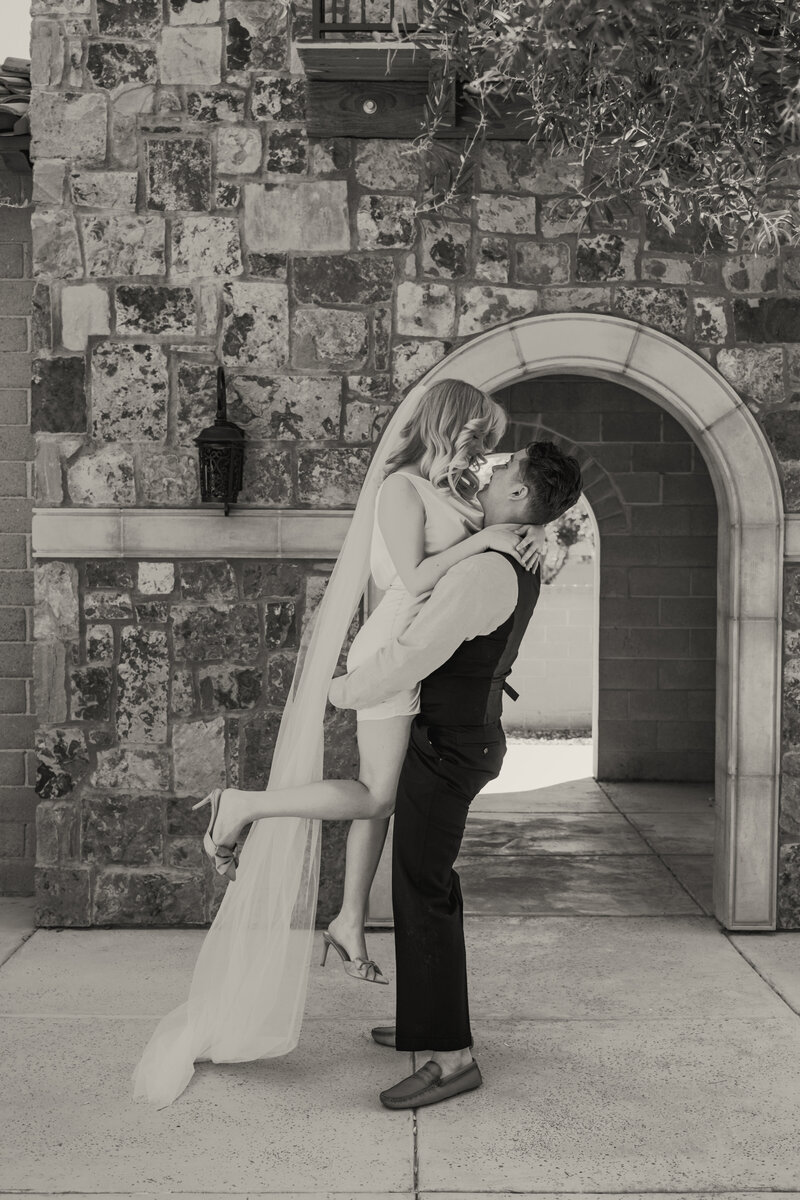Couple Holding Each Other Under An Arch in Litchfield Arizona