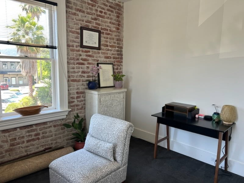 Peaceful counseling space with soft lighting, greenery, and seating designed for comfort and connection