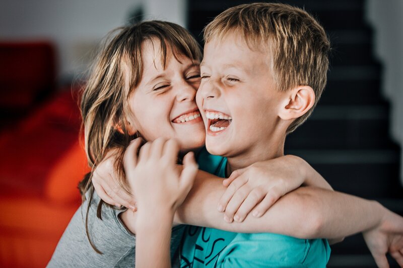 candid-portrait-of-young-boy-and-young-girl-having-fun-hugging-each-other-and-laughing-out-loud_t20_vK62r3