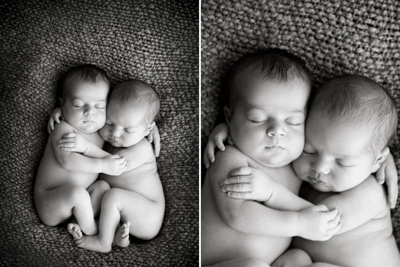 Black and white image of newborn twins hugging