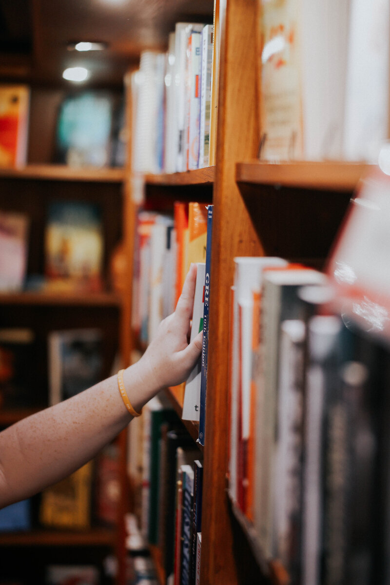 Jessie pulls a book off the shelf
