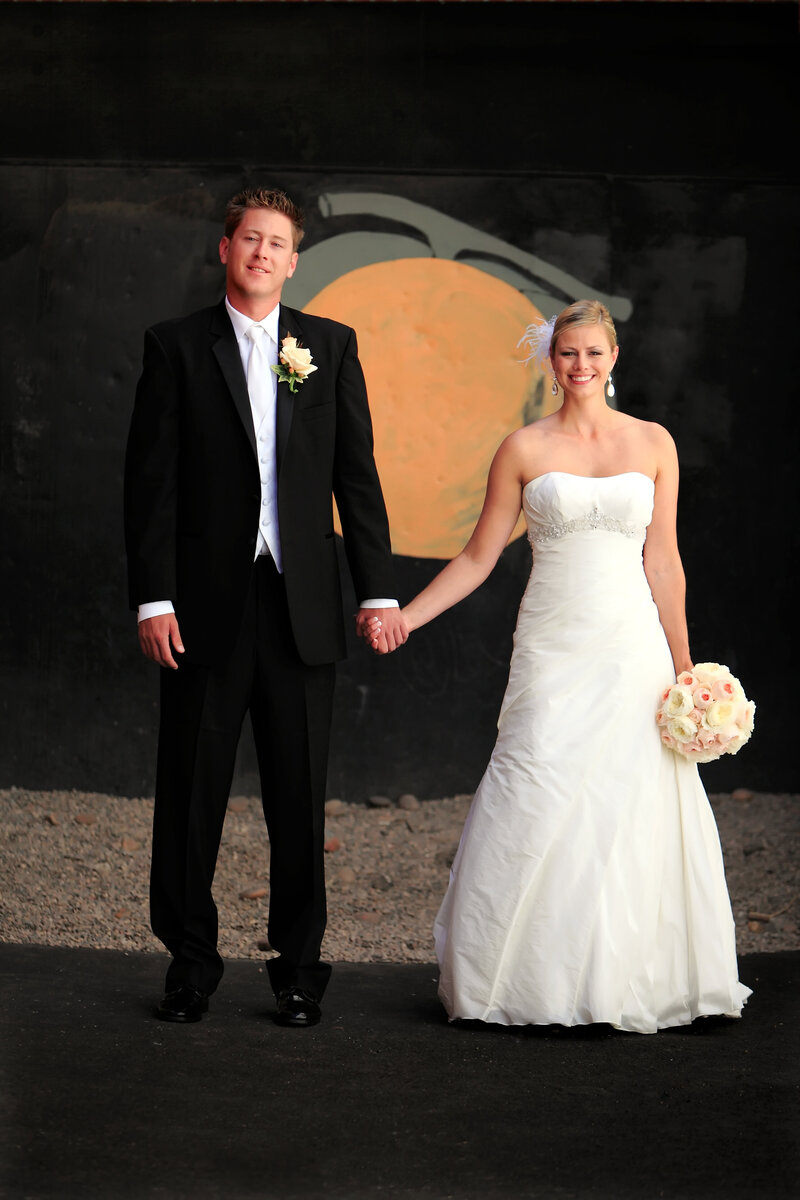 Photo of wedding couple being photographed at orange circle