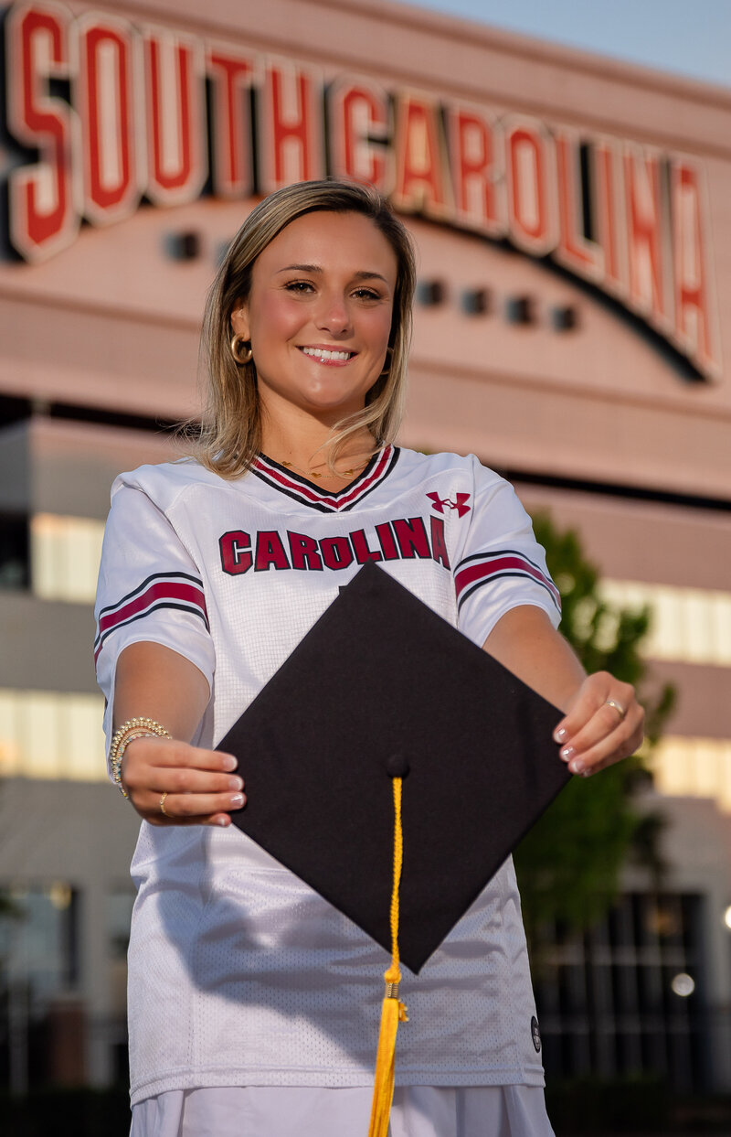 A girl posing for her senior photos at Williams Brice Stadium at University of South Carolina