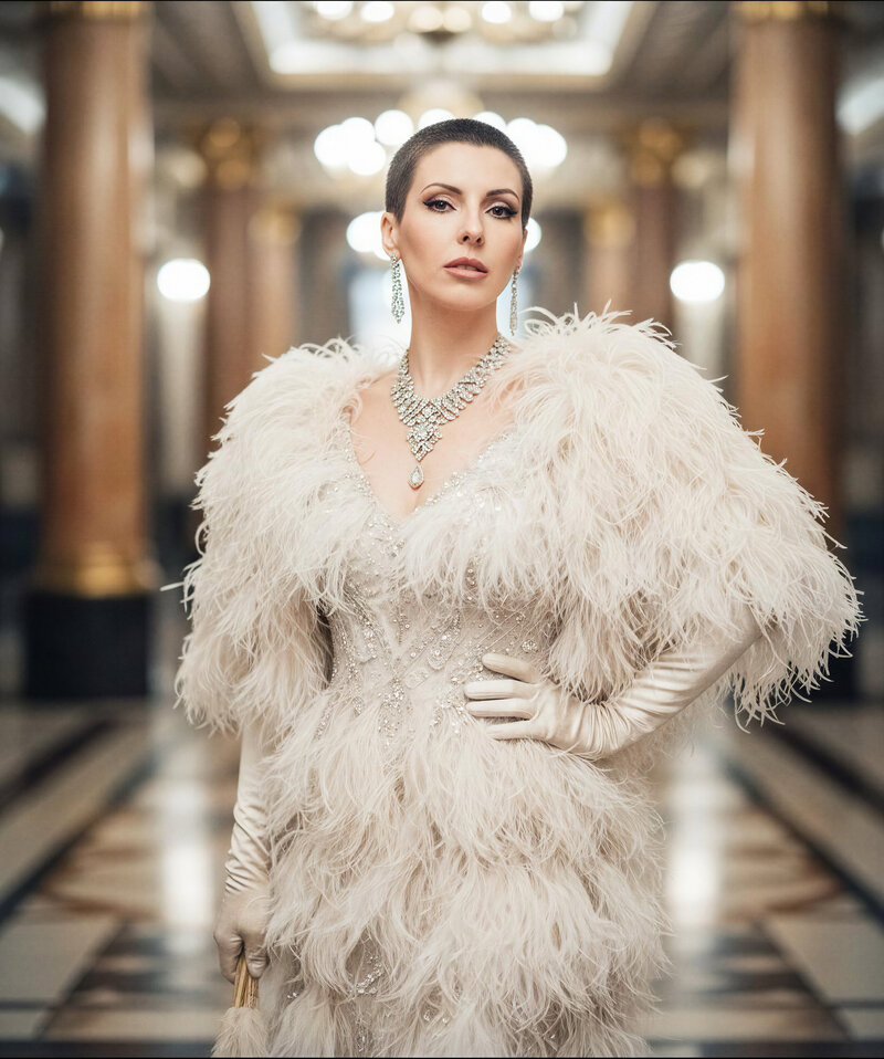 Cinematic portrait of Jasmina Kimova in a grand monochrome interior wearing a feathered gown, styled as a retro mentor introduction for personal brand website