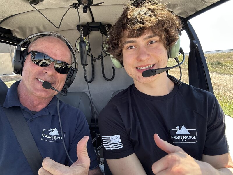 owner joe mattress smiling in front of r66 helicopter