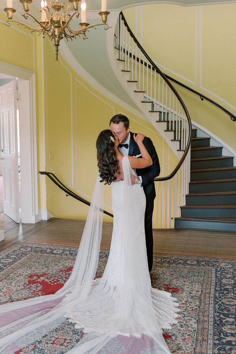 bride and groom kiss after first look