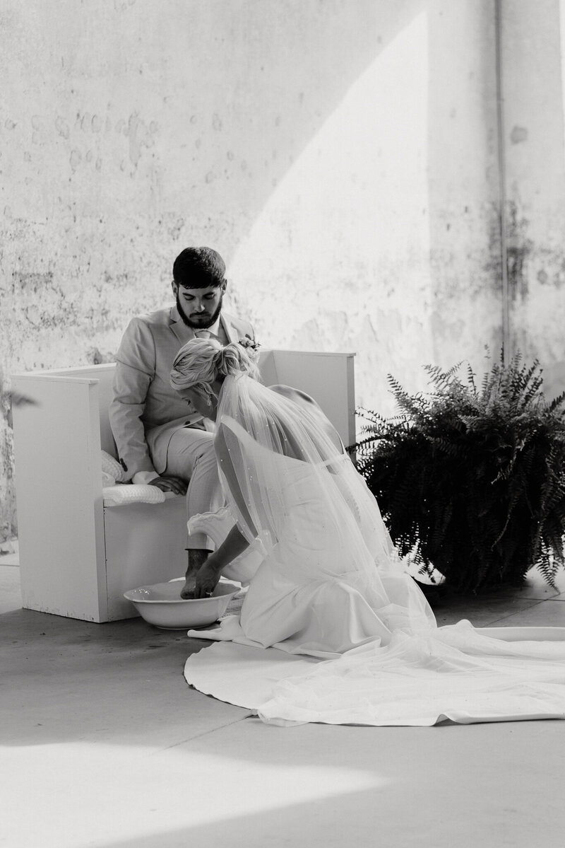 bride washing grooms feet