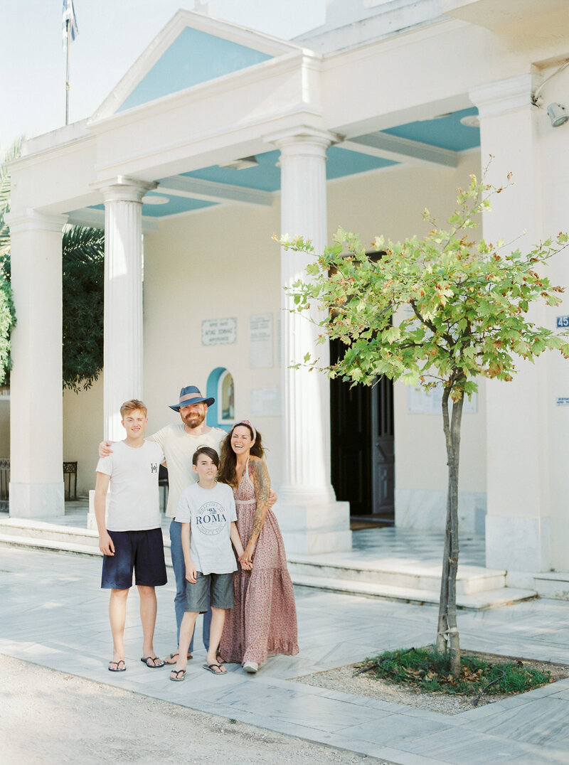 Isabelle Hesselberg with her family standing in front of a large white palazzo