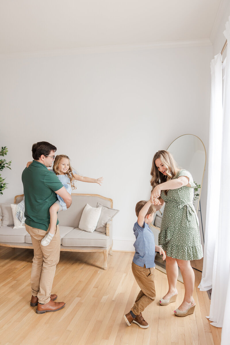 parents dancing with their kids during a family photography session