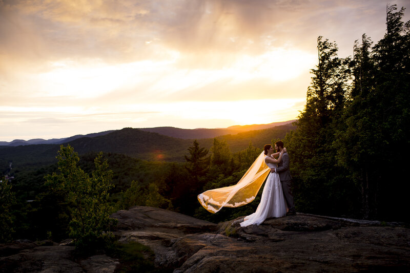 Photos of a wedding couple on the top of a mountain at sunset
