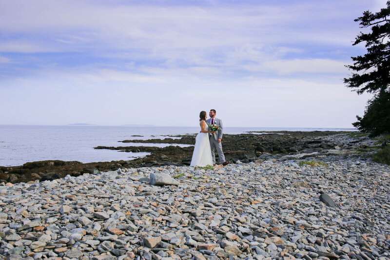 Bride and Groom standing together on rocky beach | Bar Harbor, Maine Wedding Photography