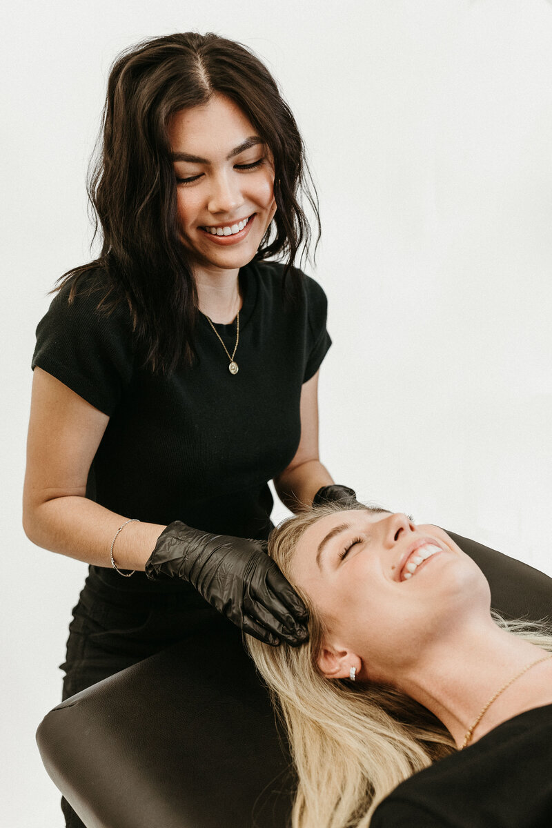 A student learning how to use a Hydrafacial machine, one of the advanced skincare treatments at Savant Aesthetics Institute.