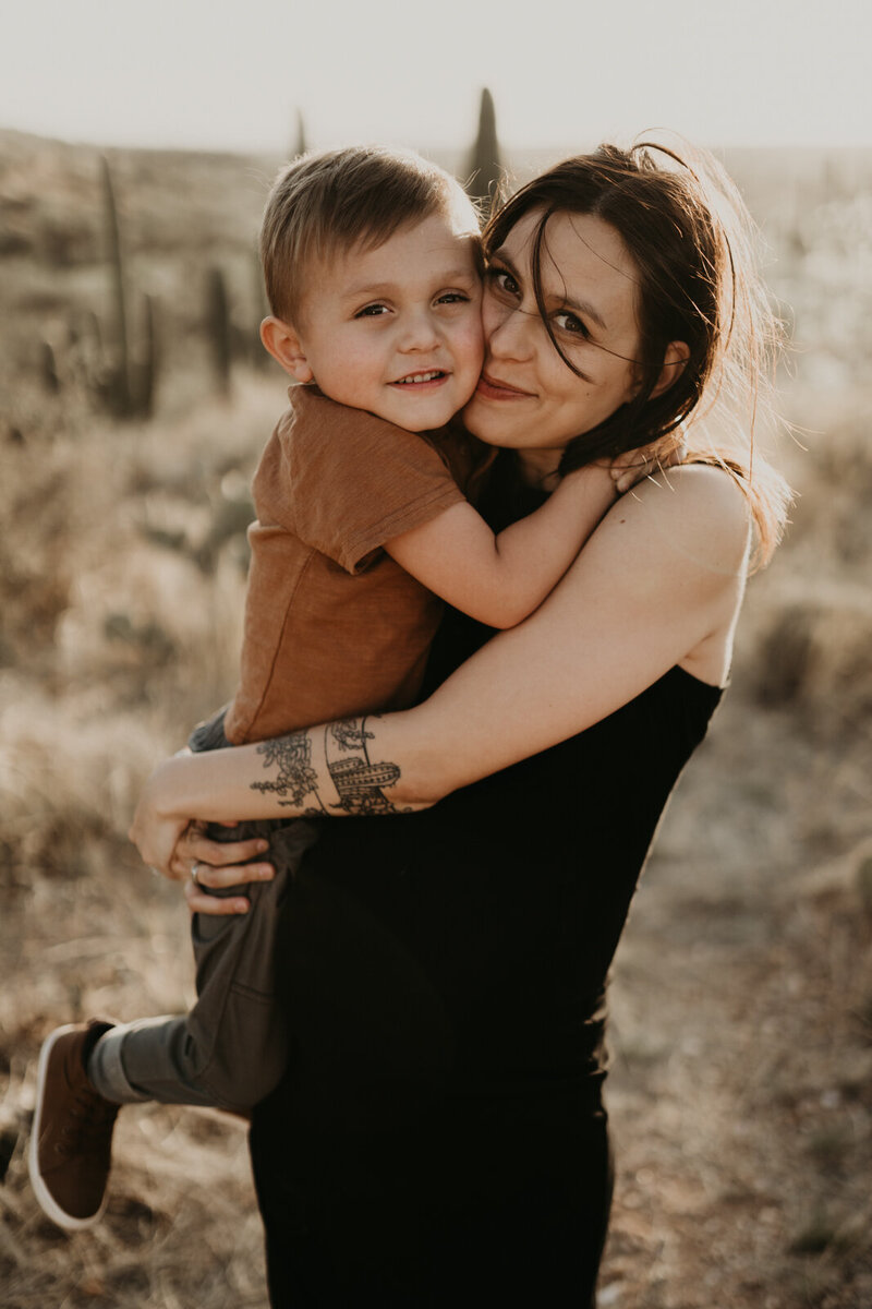 pregnant mom wearing minimal black dress with son