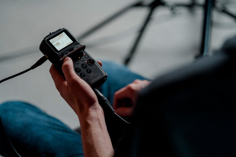 A Storyteller team member's hands holding an audio monitor.