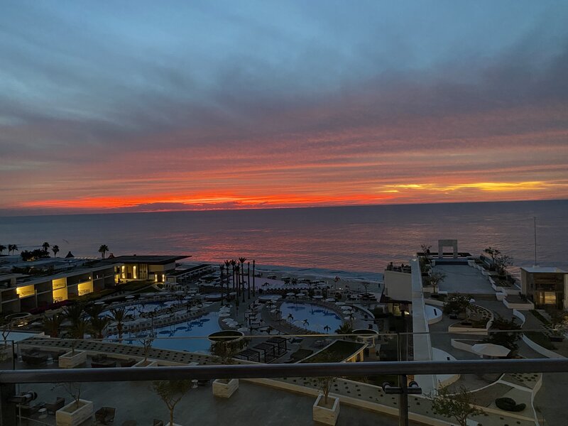 Breathtaking ocean sunset view from the rooftop pool deck at Le Blanc Los Cabos, an upscale all-inclusive resort perfect for romantic getaways.