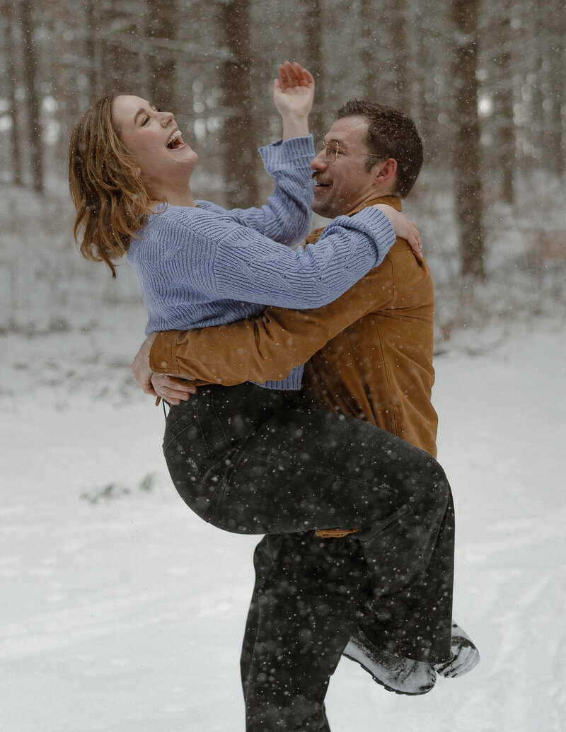Engaged couple taking winter engagement photos at Lebanon Hills in Eagan, Minnesota