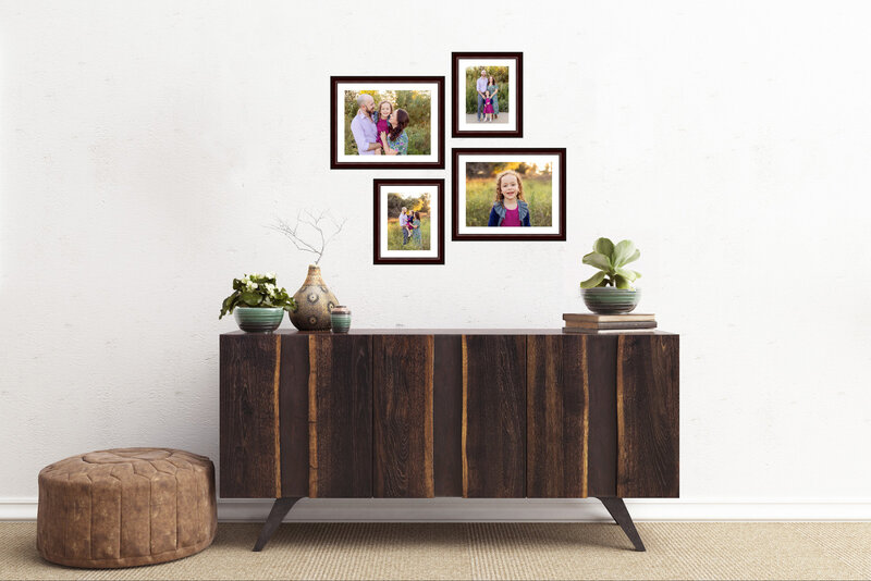 bright and natural family portraits framed above a wood table
