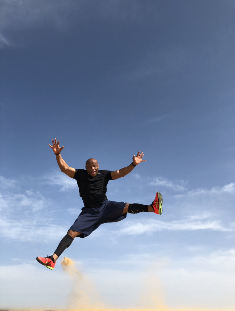 Man jumping in front of blue sky