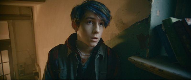 A quiet moment of reflection in a school hallway, bathed in soft window light.