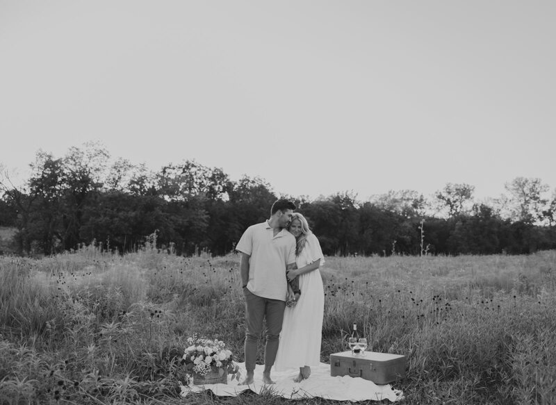 black and white engagement photos in field in shawnee kansas. romantic and timeless images that are authentic and candid moments