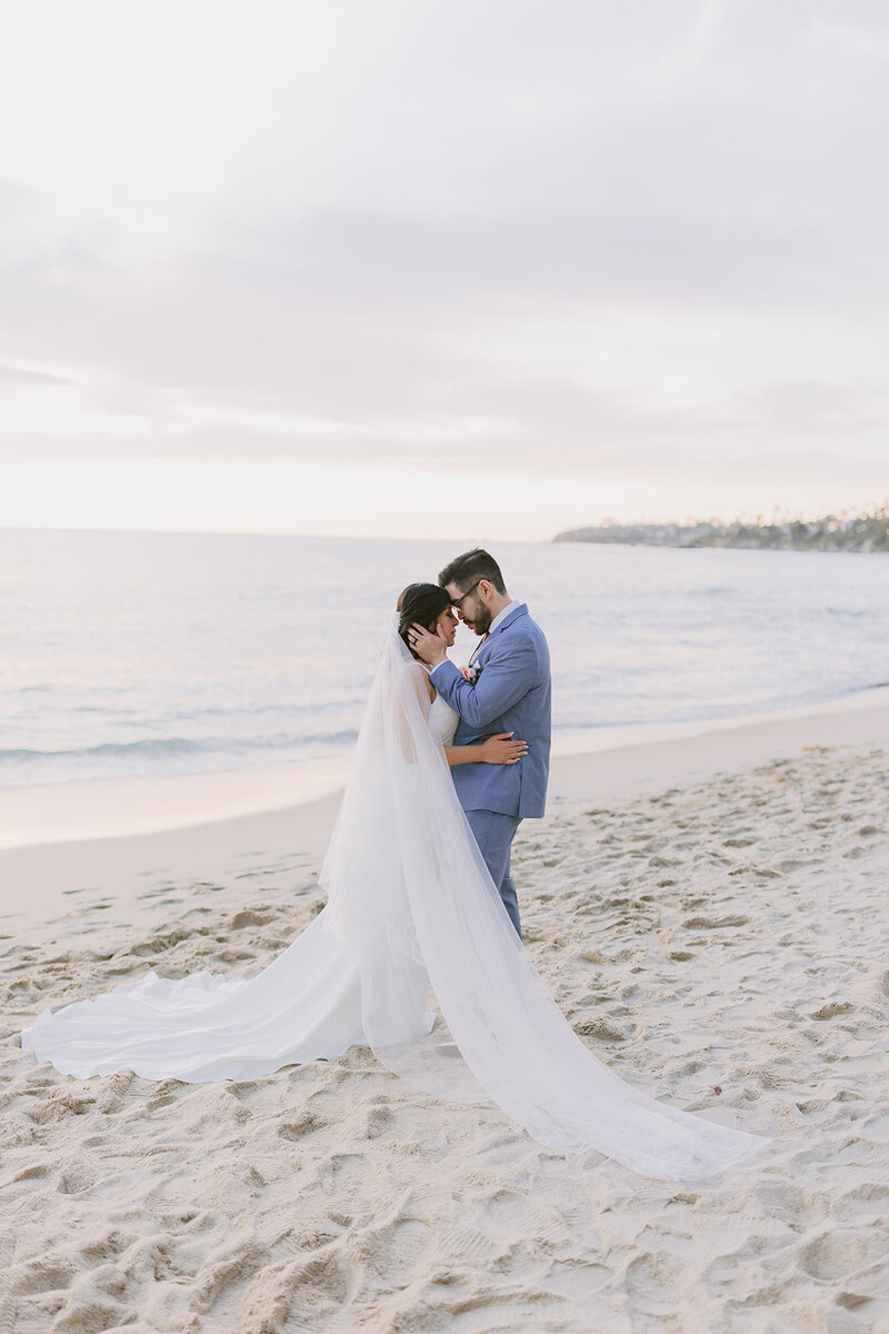 Bride and Groom holding hands standing in front of Eiffel Tower in Paris France.
