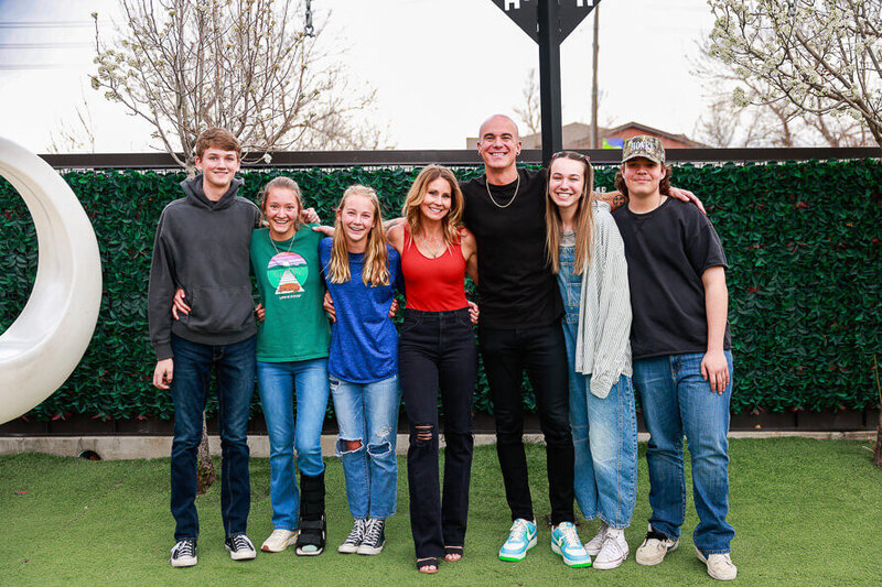 Group photo of woman and man with their 5 teenagers right after they got engaged at Viewhouse Centennial in Colorado.