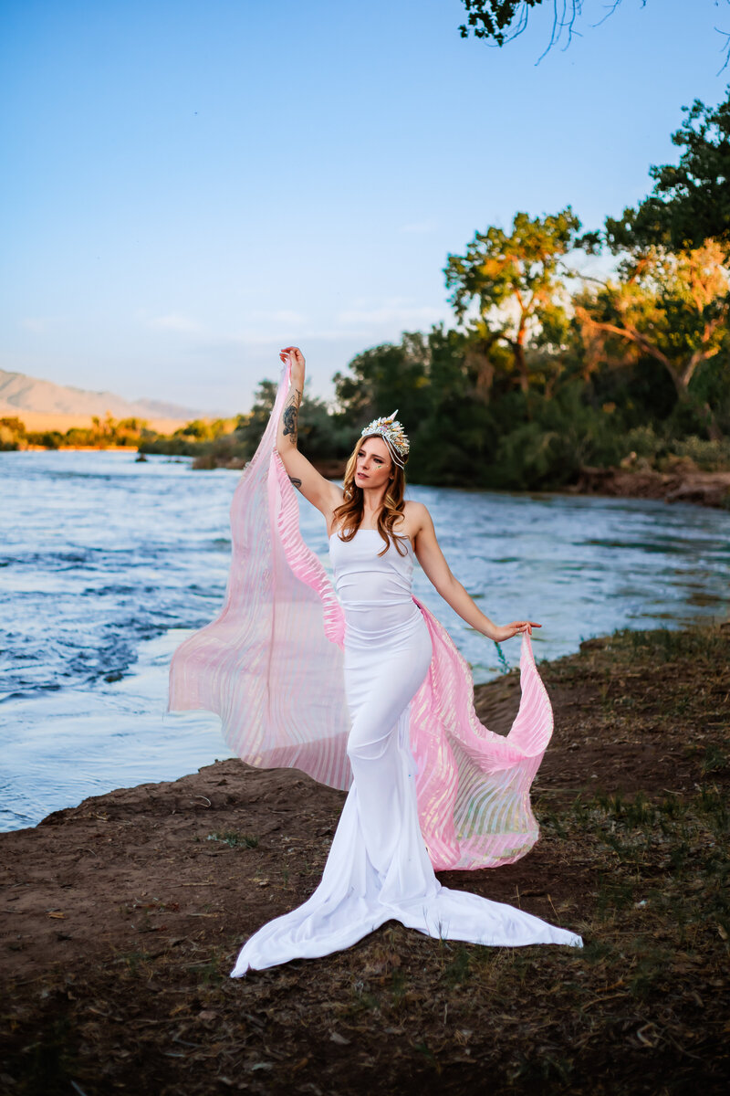woman in fabric drape by water photo