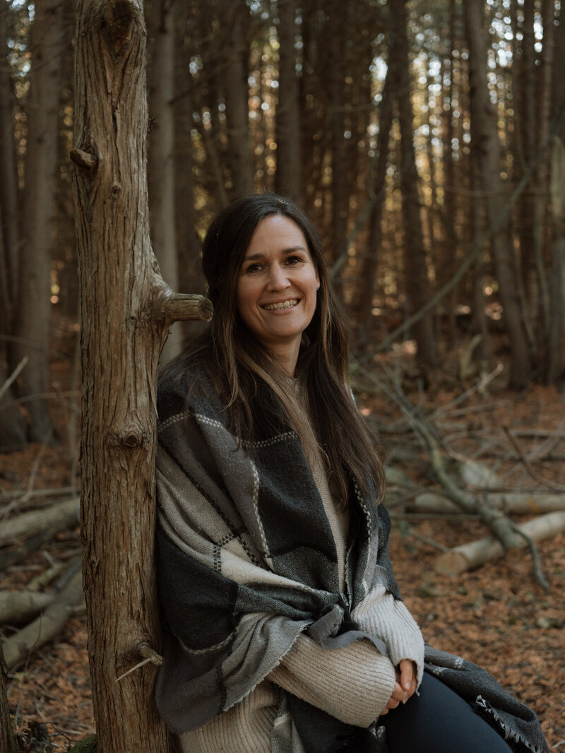 Jasmin smiling in a purple sweater
