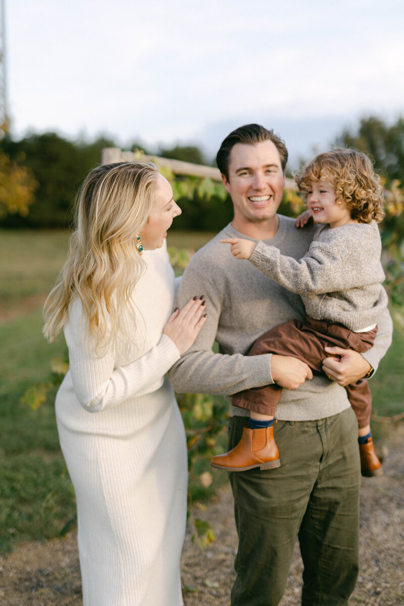 knoxville tennessee newborn photographer family snuggled up on the floor together holding each other with baby looking at camera