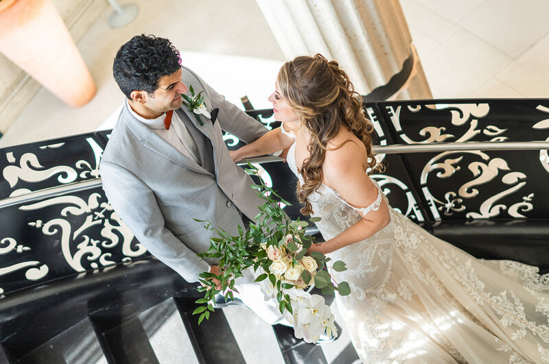 Bride and groom standing together on the ornate staircase at the Mondrian South Beach, captured by Miami wedding photographer during their wedding day photo timeline.