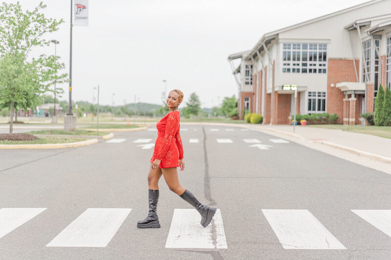 senior girl walking outside of her high school taken by senior photographer in Nokesville, VA