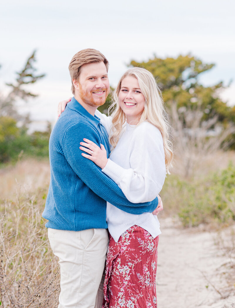 Couple smiling and laughing during a cozy engagement session in the NC.