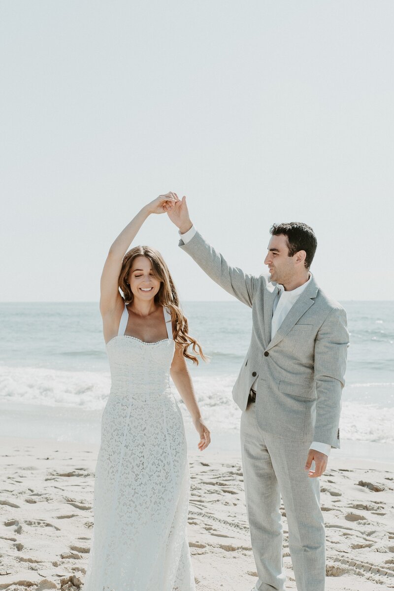 bride and groom dancing on beach in Los Angeles, CA