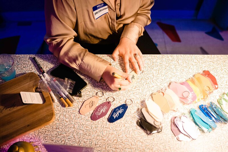 woman sitting at a table with calligraphy hotel room keycards