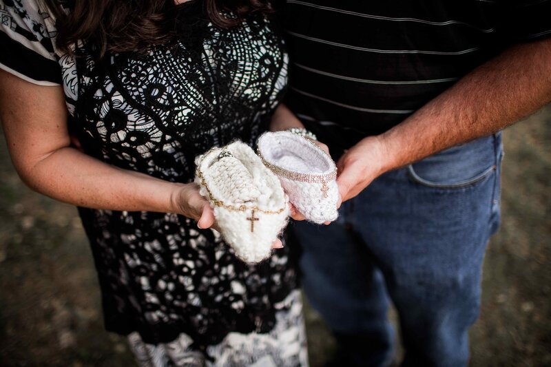 grieving parentswith knit crochet cradles in memory of stillborn babies in heaven