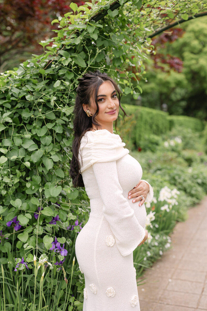 Family of four smiling in a green park during their maternity photos with missy marshall