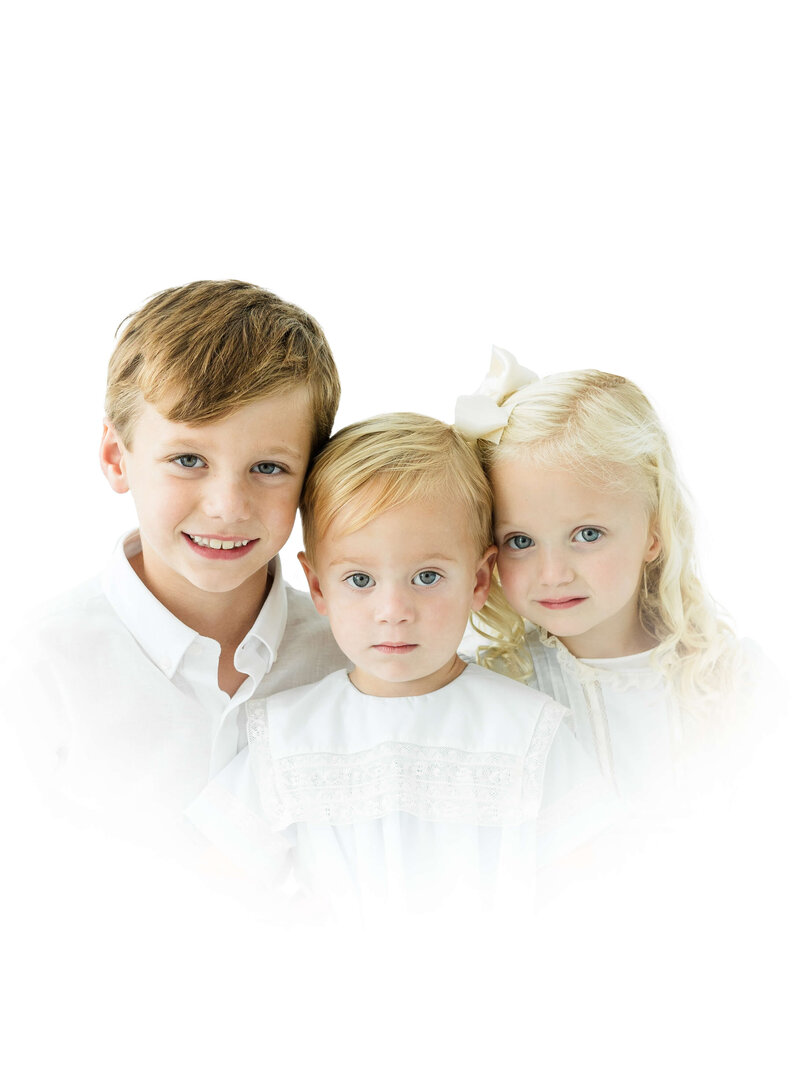 Three children sitting and smiling for heirloom photography in Dothan Alabama Photography Studio