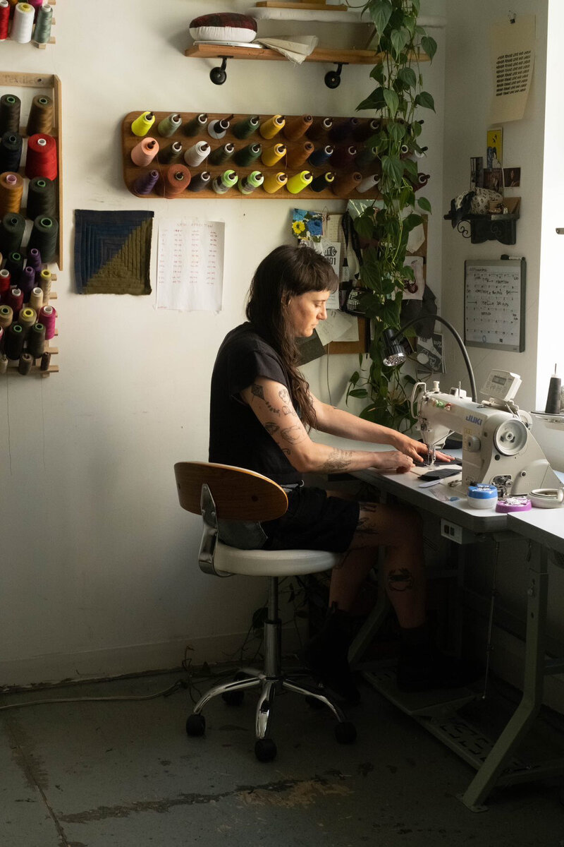 person sewing at table