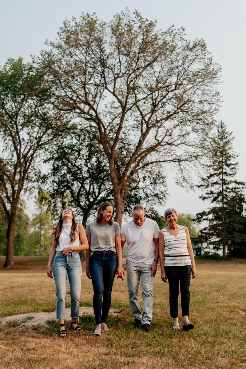 Family laughing and walking together for relaxed photos 