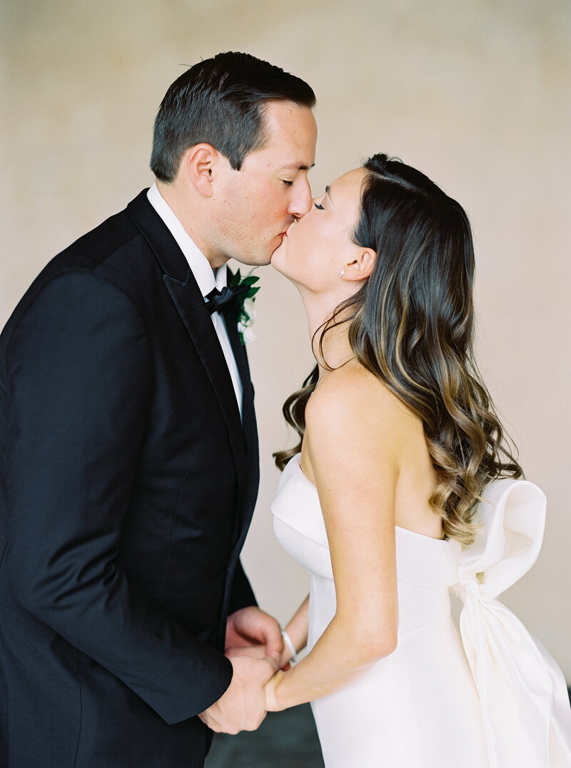 Couple kissing on wedding day