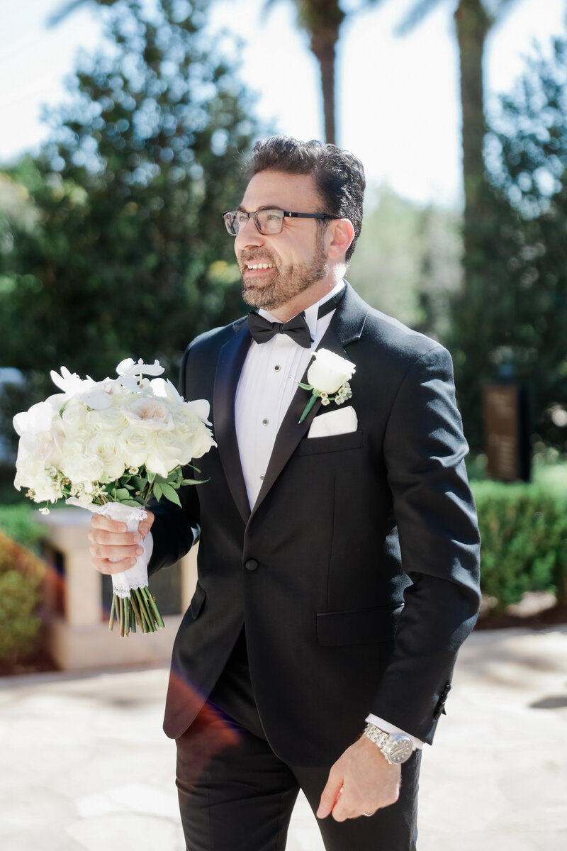 groom's reaction to the first look at the grand staircase at a wedding at the four seasons Orlando by Florida wedding photographer.