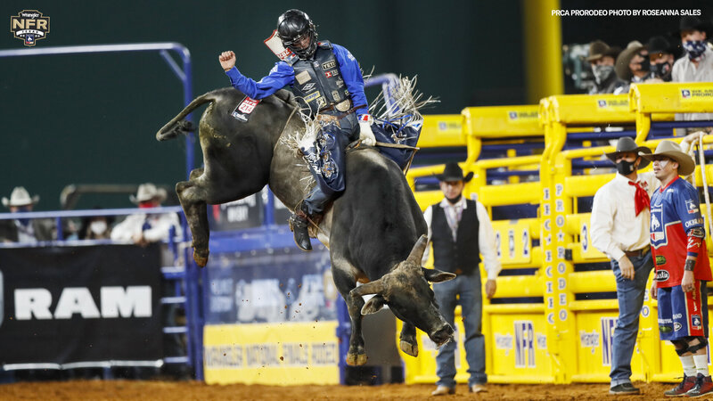 Professional bull rider maneuvering a bull with rodeo elbow braces