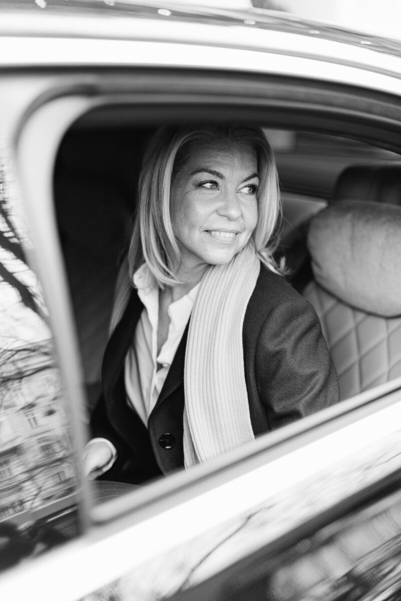 Michaela Grote sitting in her private limousine after a client meeting at Hotel Imperial in Vienna
