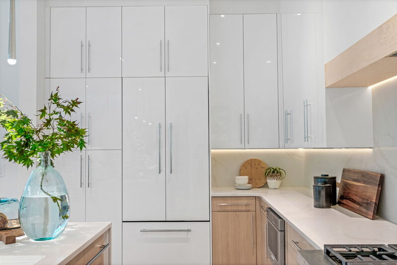 Glossy white panel kitchen with panel ready fridge