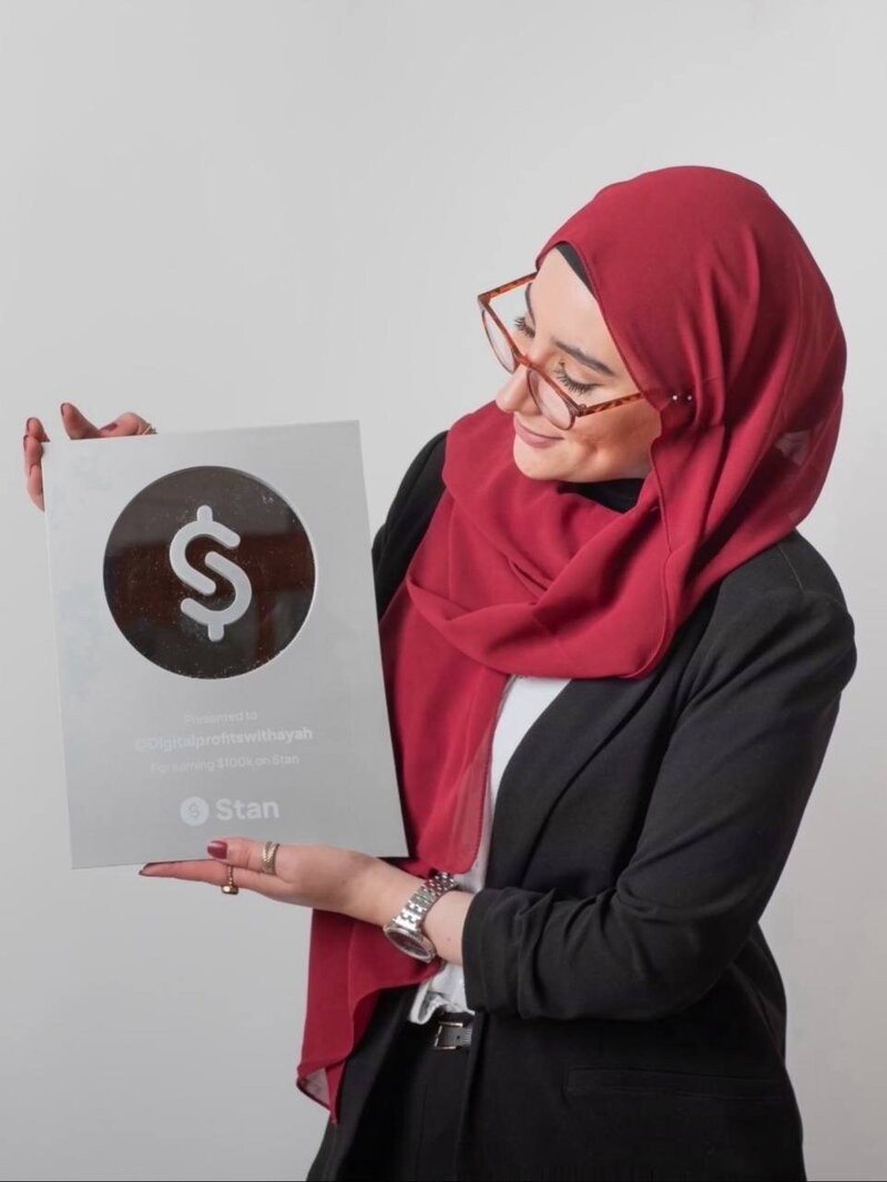 Ayah Official celebrating $100K in sales on Stanstore, representing her success as a digital educator and business mentor helping women scale online income with clarity and authority.