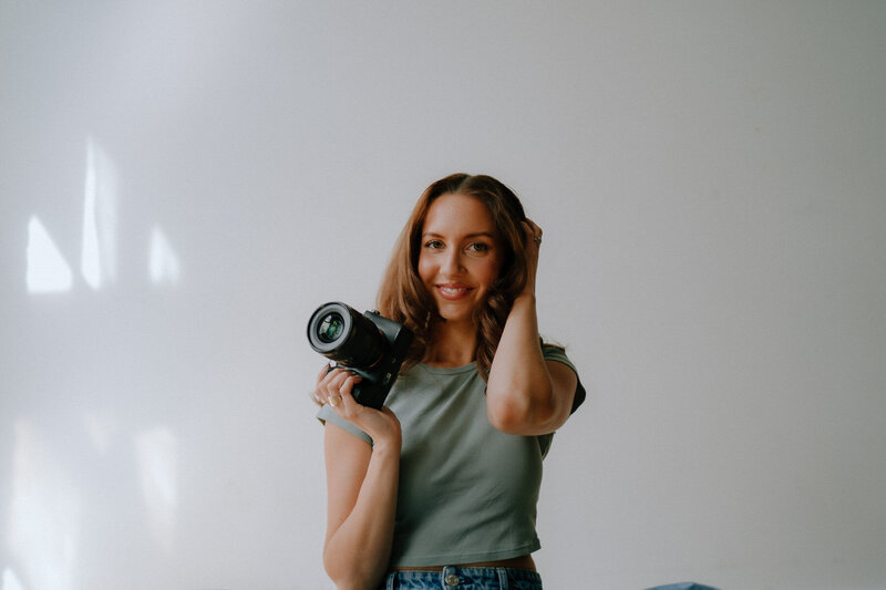photographer smiling with a camera on her head