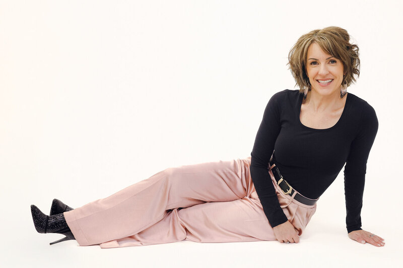 woman sitting on the ground wearing pink and black