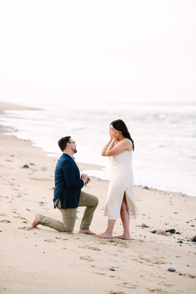 a nauset light beach proposal with the guy on his knee during a  cape cod surprise proposal session